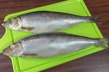 Salted herring on a cutting board.
