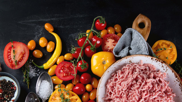 Ingredients for cooking - minced meat, tomatoes and spices.