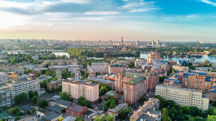 Fototapeta premium Aerial top view of Kyiv cityscape, Dnieper river and Podol historical district skyline from above, city of Kiev, Ukraine 