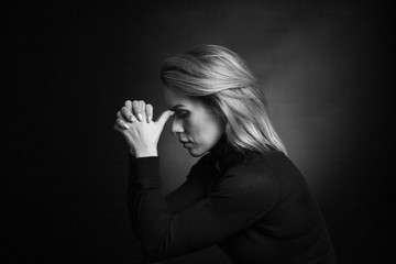 Dramatic black and white portrait of a beautiful woman on a dark background