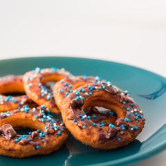 Donut on a plate and on a wooden table.