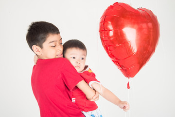 Boy  sibling with balloon  heart shape of love
