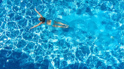 Active girl in swimming pool aerial drone view from above, young woman swims in blue water, tropical vacation, holiday on resort concept   © Iuliia Sokolovska
