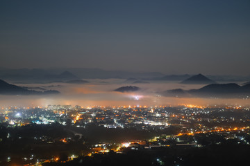 Naklejka na ściany i meble The atmosphere at night over the city of Loei Province when viewed from the peak of Phu Bo Bid.