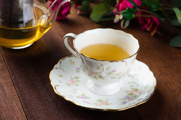 Cup with green tea on grey wooden background