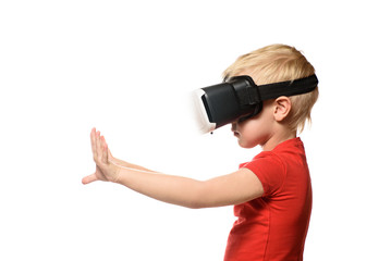 Little boy in a red shirt is experiencing virtual reality holding hands in front of him. Isolate on white background. Technology concept