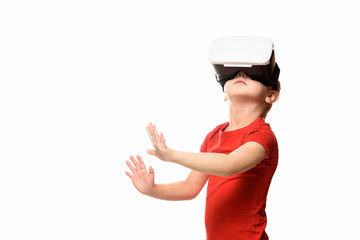 Little boy in a red shirt is experiencing virtual reality holding hands in front of him. Isolate on white background. Technology concept