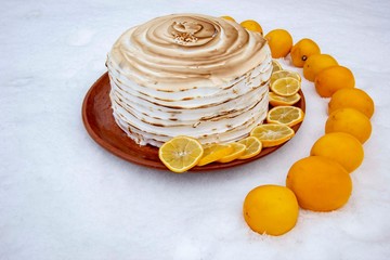 cake with lemons and baked swiss meringue