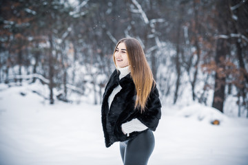 Fototapeta na wymiar Nice plus size lady at nature, autumn- winter season time, girl with attractive appearance