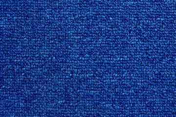 Close up of dark blue color carpet texture background with seamless pattern.