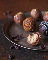 Homemade chocolate truffle with blue cheese and white chocolate on dark background. Close up. Selective focus. Delicious dessert. Confectionery recipe.