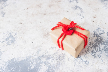 Valentine gift box with ribbon and heart decor. Close up. Selective focus.