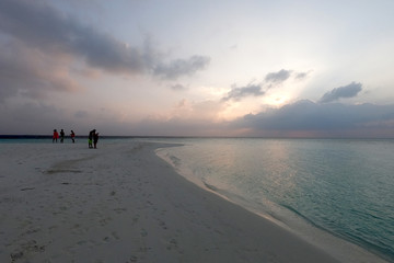 sunset on a tropical beach in maayafushi island, maldives