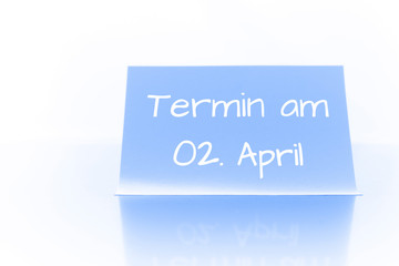 Termin am 2. April - blauer Zettel mit Notiz
