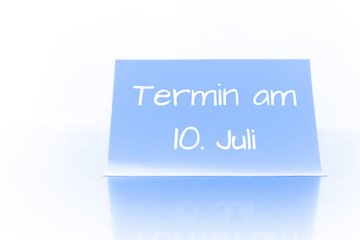 Termin am 10. Juli - blauer Zettel mit Notiz