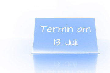 Termin am 13. Juli - blauer Zettel mit Notiz