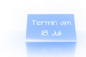 Termin am 18. Juli - blauer Zettel mit Notiz