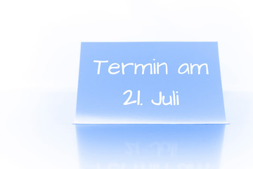Termin am 21. Juli - blauer Zettel mit Notiz