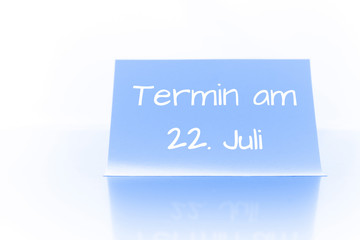 Termin am 22. Juli - blauer Zettel mit Notiz