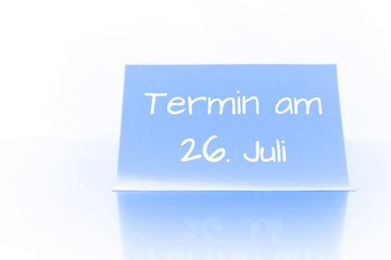 Termin am 26. Juli - blauer Zettel mit Notiz
