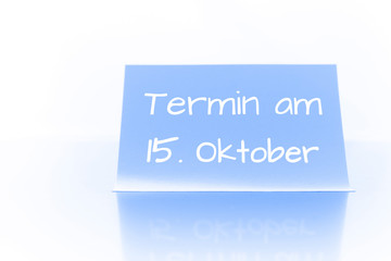 Termin am 15. Oktober - blauer Zettel mit Notiz