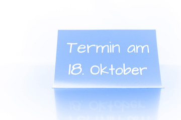 Termin am 18. Oktober - blauer Zettel mit Notiz