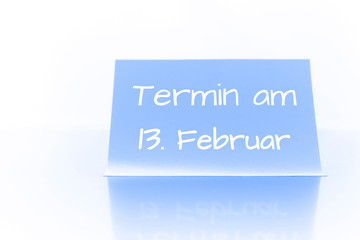 Termin am 13. Februar - blauer Zettel mit Notiz