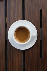 Hot coffee on wood background.