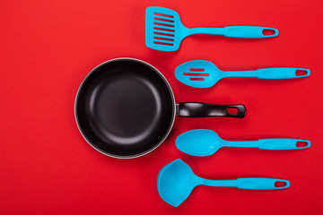 Kitchen utensils for cooking in kitchen isolated with copyspace on red background