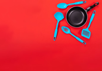 Kitchen utensils for cooking in kitchen isolated with copyspace on red background