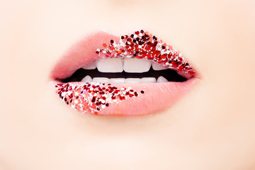 Pastel pink color lips with glitter and tint. Matte pink tint and red glossy glitter make-up