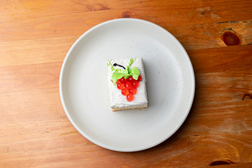 Strawberry cake on white dish, isolated.