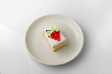 Strawberry cake on white dish, isolated.