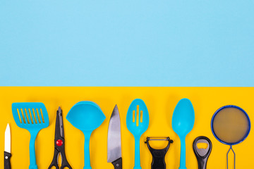 Design concept of kitchen utensils isolated with copyspace on blue-yellow background