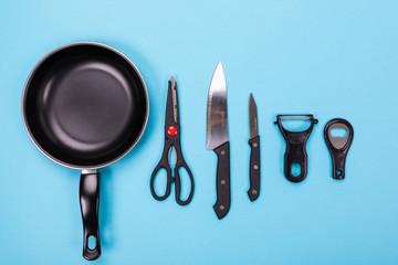 Close up picture of group of kitchen utensils with copyspace on blue background