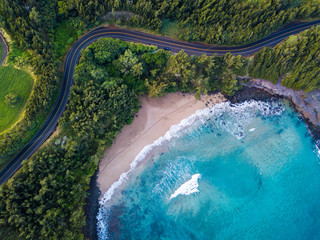 Aerial view of the sandy beach and curved asphalt road on the west coast of Maui. Hawaii - obrazy, fototapety, plakaty