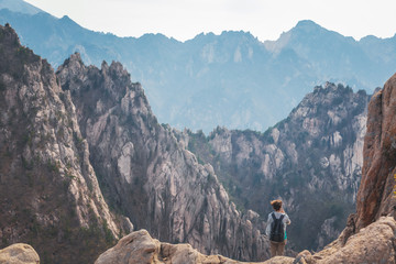 A girl traveling in a gorge in the mountains of Seoraksan National Park in South Korea, a popular destination for travel in Asia