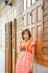 Portrait of Asean woman wearing a native of northern Thailand  background wooden wall.
