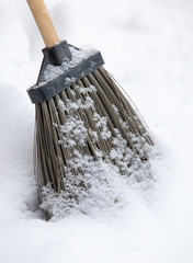 Broom on the snow in winter