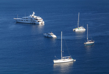 Yachts and boats in crystal clear azure water at Paleokastritsa. Corfu island, Greece. Holidays in Greece.