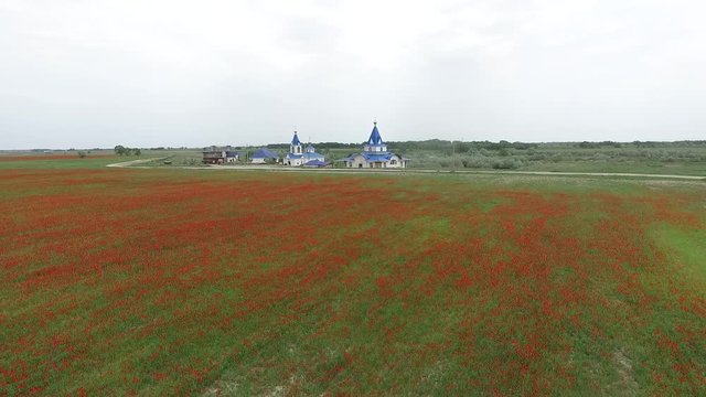 Blue Church. Spring field. Overcast weather. Video from the air.