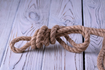 rope with knot on wooden background