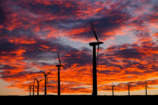 Silhouette of windturbines on an amazing sunset