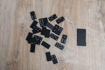 Dominoes on a wooden table. Parts of game of domino on wood.
