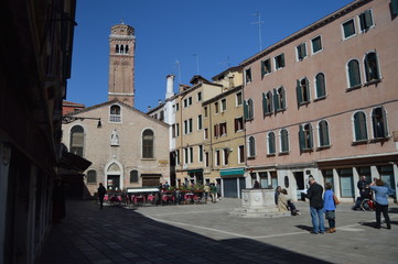 Strolling through the Sestiere of San Polo, from Scuola dei Calegheri to San Rocco. With the Frari Bell Tower in the background In Venice. Travel, Holidays, Architecture. March 27, 2015. Italy.