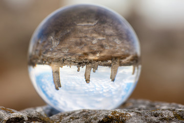 Upside down landscape of Pobiti Kamani, The Stone Forest Natural Reserve near Varna in Bulgaria, Eastern Europe - reflection in a lens ball - selective focus, space for text