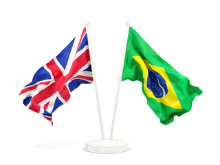 Two waving flags of UK and brazil