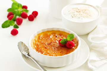 Creme brulee. dessert with caramel crust and berries.