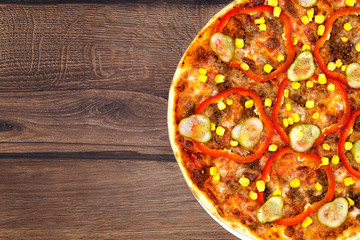 Tasty delicious fresh pizza on plate on wooden background. Photo for menu, italian food concept