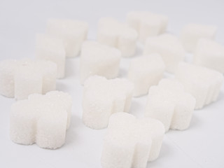 white lump sugar refined on a white background.